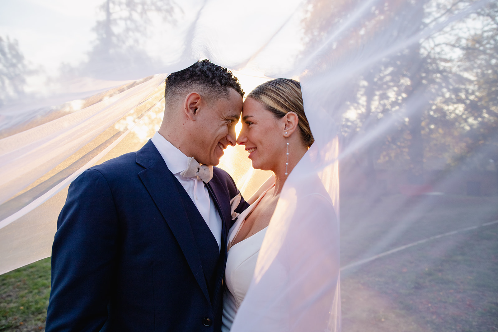 Newlyweds embracing outdoors.
